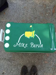 a person standing next to a green golf mat with the words mike parva on it