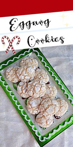 some cookies are on a green and white plate with candy canes in the background