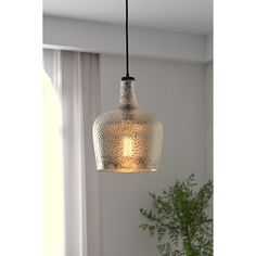 Cast a warm and welcoming glow in the foyer or bring a bit of brightness to your kitchen island with this one-light large glass pendant, which is compatible with sloped ceilings. Suspended from a black cable and secured with a black socket, its downward-facing glass shade showcases hammered glass for fun flair and accommodates one bulb of up to 60 W (not included). Assembly and installation are required for this hardwired luminary. Trent Austin Design® Finish: Silver | Trent Austin Design® Kettn Oil Rubbed Bronze Pendant Light Kitchen, Lights Above Kitchen Island, Mercury Glass Pendant Light, Oil Rubbed Bronze Pendant Light, Light Over Sink, Lights Over Island, Large Glass Pendant, Lights Over Kitchen Island, Seeded Glass Pendant