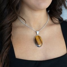 Looking for a little earthy flair? This Tiger’s Eye necklace has you covered. With its golden-brown shimmer and natural vibe, this stone brings all the warmth and glow you need to elevate any outfit. Set in sleek sterling silver, the necklace strikes that perfect balance between laid-back and eye-catching. Pendant only, the chain is sold separately here. Gemstone - Genuine Tiger's Eye 950 Sterling Silver Handmade in Taxco, Mexico Eye Pendant Necklace, Eye Pendant, Tigers Eye, Tiger's Eye, Eye Necklace, Golden Brown, Outfit Set, Tiger Eye, Handmade Silver