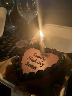 a heart shaped cake with a lit candle on it