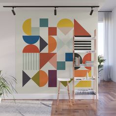 an abstract wall mural in a living room with wood flooring and white walls, along with a wooden ladder