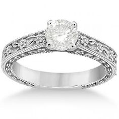 an antique style diamond engagement ring with filigrees