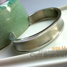 Men's wide steel cuff bracelet made from stainless steel.  Size M.Metal: high quality stainless steelLong Diameter: 2 1/2  Short Diameter:  2"Circumference:  7 3/4"Width:  a little big wider than 1/2", 14mmThickness: 2.5mmMeasurements are an approximation Engraving service is not available for this bracelet.Good quality of stainless steel jewelryhttp://360jewels.blogspot.com/2009/12/why-stainless-steel-jewelry-works.htmlThanks for your interest in our men's cuff bangle made from stainless steel. Polished Stainless Steel Bangle Cuff Bracelet, Stainless Steel Polished Cuff Bracelet, Polished Stainless Steel Cuff Bracelet, Modern Silver Stainless Steel Cuff Bracelet, Modern Stainless Steel Bangle Cuff Bracelet, Modern Stainless Steel Cuff Bracelet, Bracelet For Men Silver, Unique Bangle, Stainless Steel Bracelet Men