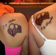 two women with matching tattoos on their backs