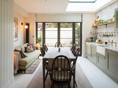 a dining room table with chairs and a couch