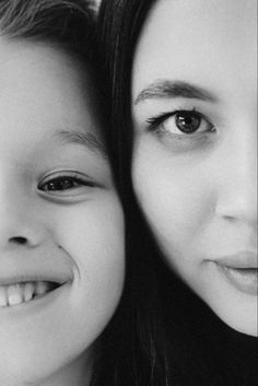 two women are smiling for the camera with their eyes wide open and one is holding her head on another woman's shoulder