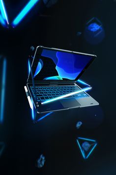 an open laptop computer sitting on top of a black surface with blue lights around it