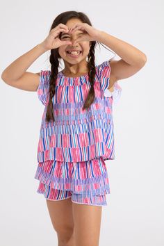 Go extra-girly in our Splash Flutter Tank with ruffle flutter sleeves and candy-colored stripes. It's even more epic paired with the matching skort! Playful Striped Tops For The Beach, Playful Ruffled Tops For Vacation, Multicolor Ruffled Tops For Fun Style, Multicolor Ruffled Tops For Playwear, Casual Multicolor Ruffled Sets, Playful Ruffled Tops For Beach, Playful Sets With Ruffles And Short Sleeves, Playful Striped Tops For Beach, Fun Multicolor Tops With Ruffles