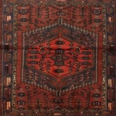 an antique persian rug with geometric design on red and blue ground, in the shape of a hexagon