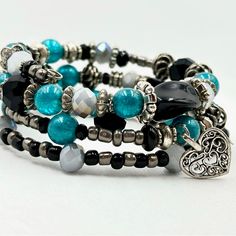 This Turquoise And Black Crystal Wrap Bracelet Is 3 Rows Of Silver Memory Wire Filled With Various Glass Beads, Crystals, And Silver Spacer Beads, Along With A Silver Heart Charm To Finish It. Crystal Wrap, Turquoise And Black, Memory Wire Bracelet, Bracelet Crystal, Memory Wire Bracelets, Bracelet Cuff, Memory Wire, Wire Bracelet, Crystal Heart