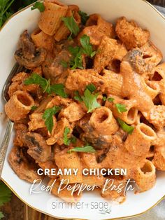 creamy chicken pasta with peppers and parsley in a white bowl