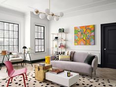 a living room filled with lots of furniture and decor on top of a hard wood floor