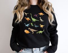 Cute Dinosaur T Shirt, Saurus Print Gift Shirts, Paleontology Women Sweatshirt, Dino Kids Birthday Tshirt, Velociraptor Tote Bag, Trex Tee  👉 Product Details: The T-Shirts, V-Necks, youth and baby suits(onesie) are unisex.👈 👉Please review all the sizing charts that were added in the product pictures. 👚 Women: Shirts will have a looser fit when choosing your regular size. If you would prefer a more fitted look, it is recommended to size down. It is based on your personal preference. 👉How Do I Order👈 1️⃣ Please review all the information provided before placing an order 2️⃣ Select the shirt type and size using the drop down menu. 3️⃣ Select the color of the shirt using the following drop down menu. 4️⃣ Need more Items? Add the current item in the cart. And If you like to add more items Black Dinosaur Print Crew Neck Top, Dinosaur Sweatshirt, Dinosaur Family, Dinosaur Hoodie, Dinosaur Tshirt, Dino Kids, Cute Dinosaurs, T Rex Humor, Books Shirt