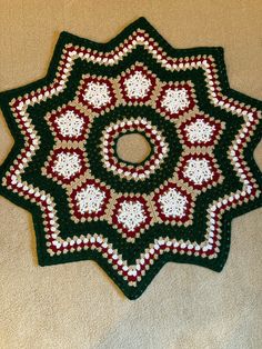 a crocheted doily is laying on the floor