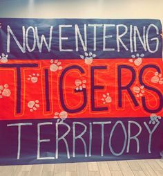 a banner that says now entering tigers territory with paw prints on the front and side