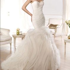 a woman in a wedding dress posing for the camera