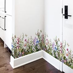 a kitchen with flowers painted on the wall