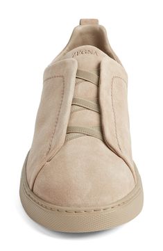 This soft and supple suede sneaker slips on easily with crisscrossed elastic at the vamp and is set on a tonal rubber cupsole for a casual aesthetic. Pull-on style Leather upper and lining/synthetic sole Made in Italy Designer Shoes Slip-on Sneakers With Suede Lining, Casual Slip-on Sneakers With Suede Lining, Slip-on Sneakers With Suede Lining And Round Toe, Comfortable Suede Sneakers With Leather Sole, Comfortable Suede Sneakers With Stitched Sole, Comfortable Suede Slip-on Sneakers With Textured Sole, Classic Slip-on Suede Sneakers, Suede Slip-on Sneakers With Textured White Sole, Suede Slip-on Low-top Sneakers