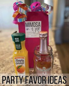 some condiments are sitting next to a pink bag on a counter top with a ribbon