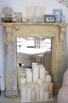 a mirror sitting on top of a mantle filled with candles