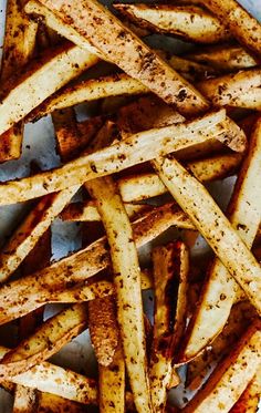 seasoned french fries on a plate with seasoning