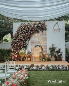 an outdoor wedding setup with flowers and greenery