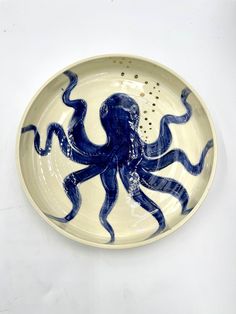 a blue and white plate with an octopus on it