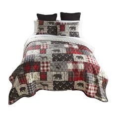 a bed covered in a plaid and black comforter