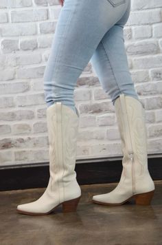 Introducing the “Tall White Boots” – a bold and stylish take on classic cowgirl boots. These striking white boots feature a tall silhouette that adds a touch of modern flair to traditional Western design. Crafted for both comfort and durability, they offer a chic and versatile option for a variety of outfits. Whether you’re dressing up or keeping it casual, the “Tall White Boots” make a statement with their unique color and timeless style. Elevate your footwear collection with these eye-catching cowgirl boots. Trendy White Heeled Boots For Fall, White Heeled Boots For Fall, White Medium Width Heeled Boots For Fall, Trendy White Wide Calf Heeled Boots, White Mid-calf Boots For Spring Outdoor Activities, Chic White Heeled Boots For Fall, Fall Season White Heeled Boots With Reinforced Heel, Cream Boots With Stacked Heel For Winter, White Boots With Stacked Heel For Fall