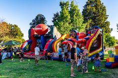 people standing in front of an inflatable football game