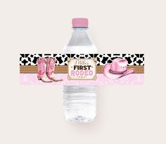 a water bottle label with pink cowboy boots and a pink hat on the top is in front of a white background