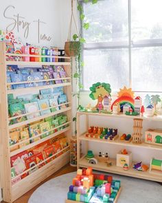 a child's room with toys and bookshelves on the floor in front of a window