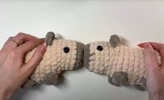 two hands holding stuffed animals in the shape of sheep's butts and noses