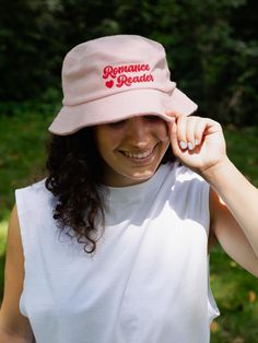 Wear your heart on your sleeve — or your head with our Romance Reader bucket hat! Product Details 100% terry cotton Embroidered artwork Color: light pink One size fits most Designed by Brittany Paige This print-on-demand product is made especially for you as soon as you order it. The Print Shop: FAQs Ordering & Shipping We cannot make any cancellations or changes to Print Shop orders for any reason. Most orders will be processed within 2 to 5 business days in addition to the shipping time for th Cotton Bucket Hat With Letter Print, Cotton Bucket Hat With Letter Print And Short Brim, Trendy Pink Cotton Hat, Adjustable Pink Cotton Bucket Hat, Pink Cotton Bucket Hat For Spring, Cute Cotton Hat With Letter Print, Pink Cotton Bucket Hat With Curved Brim, Embroidered Artwork, Romance Reader