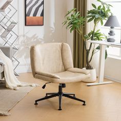 an office chair sitting on top of a hard wood floor in front of a window