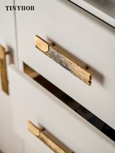 a close up of two drawers with brass handles