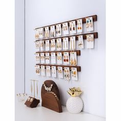 a wall mounted jewelry rack with earrings on it