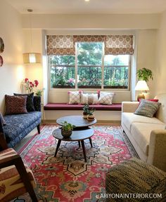 a living room with two couches and a coffee table in front of a window