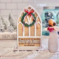 an angel figurine next to a christmas card