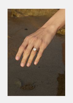 a person's hand with a ring on it