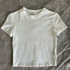 This Top Is In Great Condition And Never Worn. No Holes Or Stains. The Perfect Basic White Tee! Stretchy And Form-Fitting. Not Super Cropped. Size Medium From H&M (Divided). From A Smoke Free Home. Basic Cropped Tee, H&m White Short Sleeve Tops, Basic H&m Tops For Everyday, Basic Everyday H&m Tops, Casual White Top From H&m, H&m White Casual Top, Trendy White H&m Top, Casual White H&m Top, Basic H&m Tops