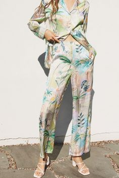 The Paradise Found Pant by WREN The Label is a must-have for the summer season. The luxurious satin fabric of this piece features an abstract tropical inspired print and a relaxed fit for exceptional comfort. Pair with the matching Paradise Found Button Down for a chic and elevated vacay look. Details Fabric: Tropical Inspired Printed Satin Fabric. Elasticized Waistband. Relaxed Fit. Model is 5'9 | Wearing a Small 100% Polyester Hand Wash Cold Trendy Work Outfit, Paradise Found, Top And Pants Set, The Paradise, Feminine Dress, Spring Shirts, Feminine Outfit, Shirt And Pants, Wren