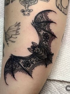 a bat tattoo on the right leg