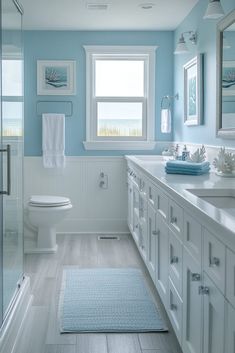 a bathroom with blue walls and white cabinets is pictured in this image, it appears to be very clean