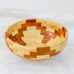 a wooden bowl sitting on top of a white table