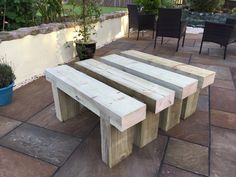 a wooden bench sitting on top of a stone patio