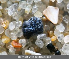 several different colored rocks and pebbles on the ground