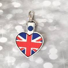 a heart shaped keychain with the british flag on it's front and back