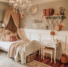 a bedroom decorated in pink and white with flowers on the wall